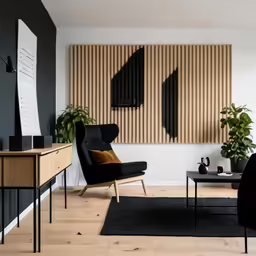 a living room has black furniture and two large vertical panels