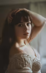 a woman in a white dress posing for a picture