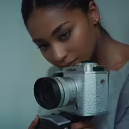 a woman takes a picture with an old camera