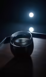 a cup with black liquid in it sitting next to a wall