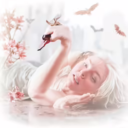 a woman laying on the ground holding a flower