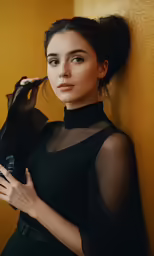 a woman in black is holding an umbrella