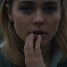 a woman holding her hands to her face