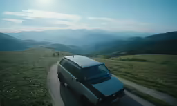 the suv is on the side of the mountain road
