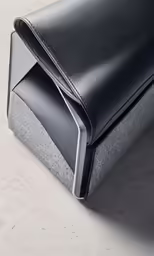 this is a leather case on top of some concrete