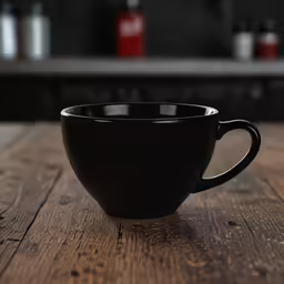 a cup on the table in a dark colored setting