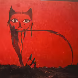 cat with arrow drawn on wall in rural area