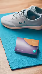 shoes and a business card are sitting on a mat