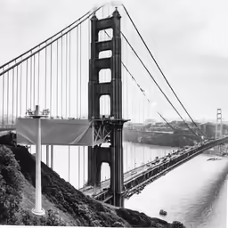the view of a bridge across a large river from atop of the hill