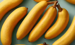 closeup of several ripe, yellow, ripe bananas