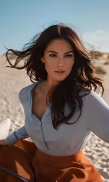 a beautiful woman standing in a sand field