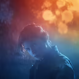 a person looking away from the camera and behind her
