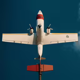 an airplane flying by the sky in the day