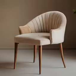 the beige fabric with wooden legs is in front of a brown wall
