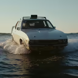 a car is driving in the water while being towed