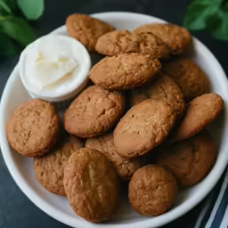 a white plate with cookies and whipped cream