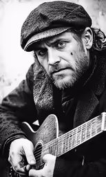 a man wearing a beret and playing an acoustic guitar