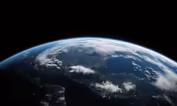 the earth seen from space, with some clouds in the sky