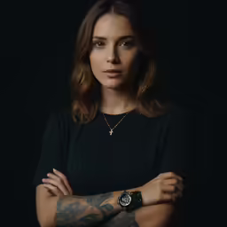 the woman is posing with her arms crossed