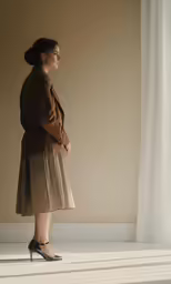 a woman standing up in a chair, with her hands on her hips