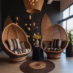 two chairs, one with two pillows on them and the other with large woven seats
