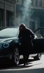 the woman stands next to the car, with a hood on