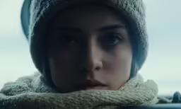 a young lady is wearing a scarf and hat