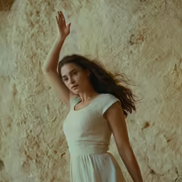 an attractive young woman holding her hand up