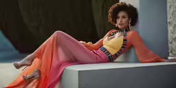 a woman sitting on top of a concrete bench