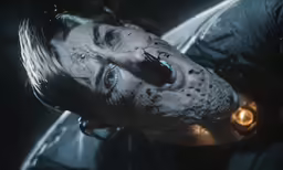 a person with black skin and a white nose wearing a mask