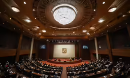 a large conference room with a clock on the ceiling