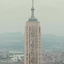 view of large building with clock on top from the top floor