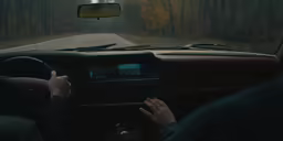 a person driving a car down the road