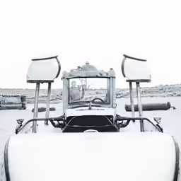 a view of snow from a car roof with four front lights and three rear seats
