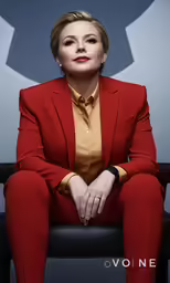 the woman is sitting down for a picture