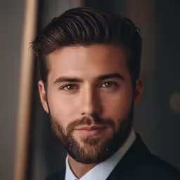 a man in suit and tie is smiling