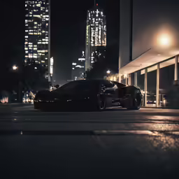 a dark sport car is parked next to the street