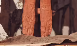 hands and legs with dirt on them in a room