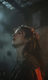 a young woman looking upwards into the air