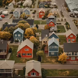 an aerial view of many houses on a street corner
