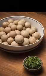 a bowl full of potatoes and a small bowl full of peas