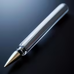 a pen with metal tips on black surface