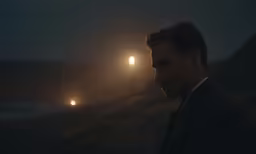a man is in the dark by a lamppost at night