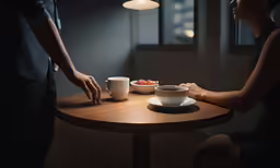 a person and the bowl on the table are being served