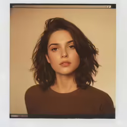 an artistic image shows a woman with brown hair and brown sweater