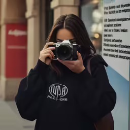 a woman taking a photo with a camera