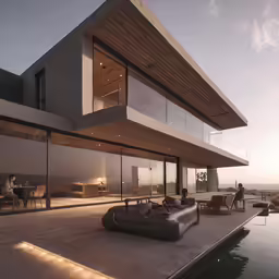 a beach front home overlooking a body of water at night