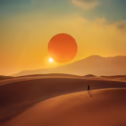 a person walking down a sandy hill with the sun setting