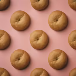 doughnuts laid out on top of pink paper
