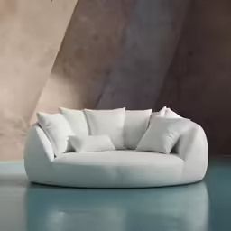 a white couch is shown next to some beige walls